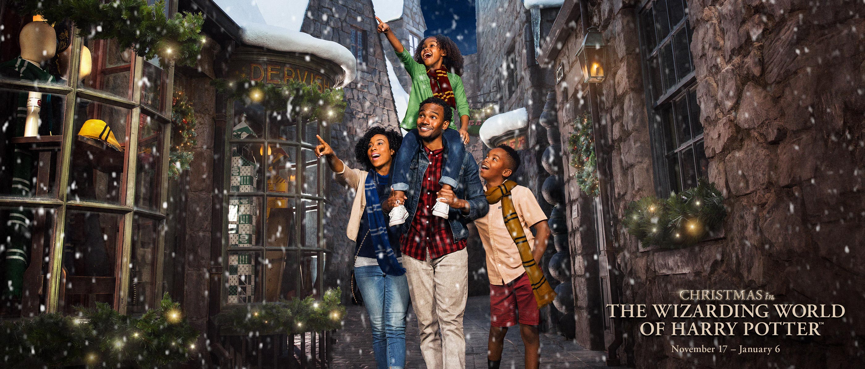Family of four walks through the Wizarding World of Harry Potter during snowfall